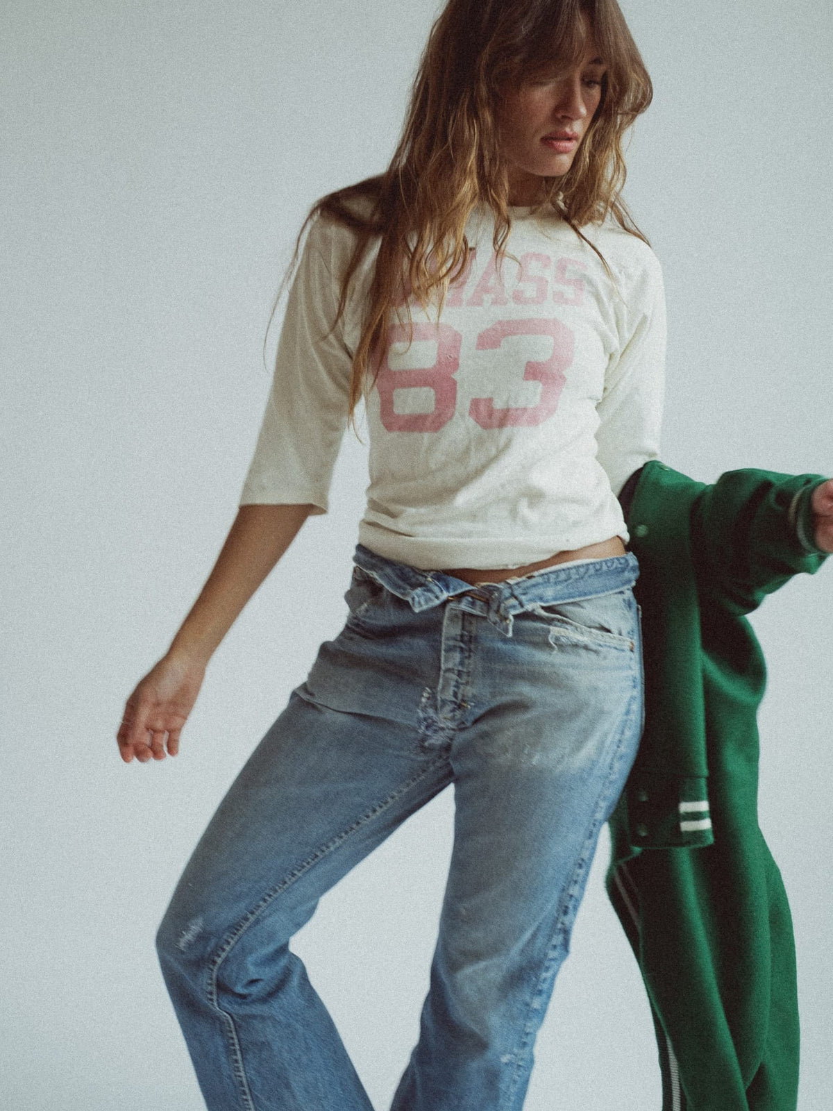Champion cream three-quarter sleeve tee printed UMASS 83 in faded red, worn with jeans