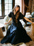 MILLE Victoria Dress in Black – fitted bodice and tiered maxi skirt, front view